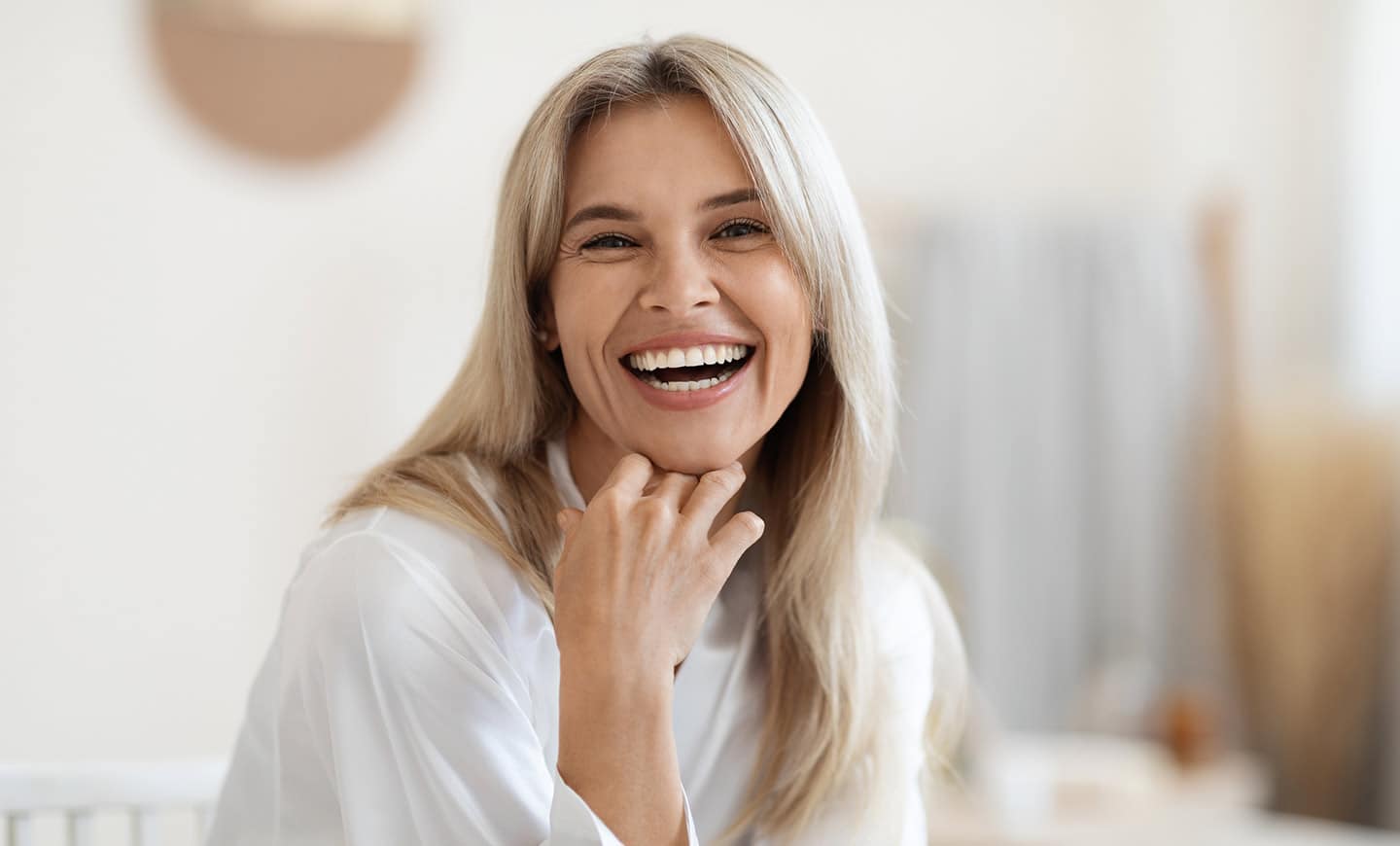 mature older woman smiling because she followed tips on how to age gracefully.