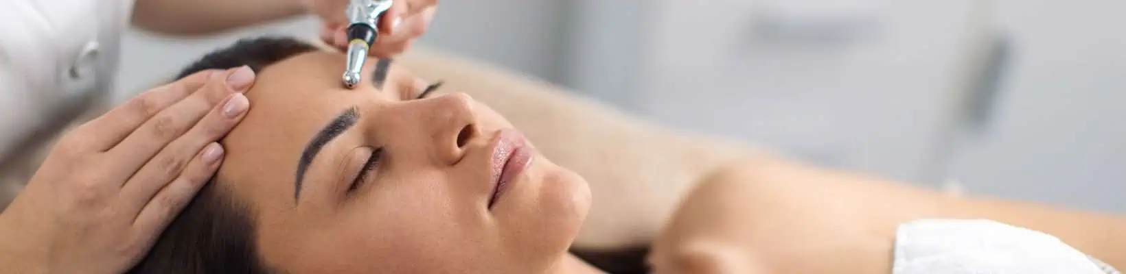 woman having laser treatment done on face